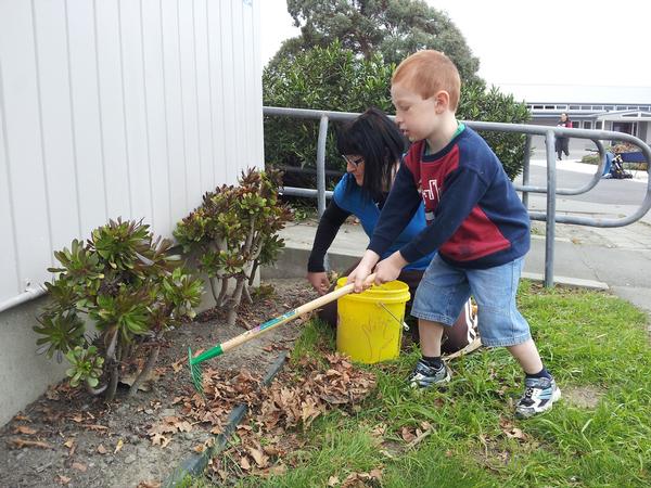 Nicole Cunningham, a teacher at Freeville School helps Ewan Bates a Freeville student 